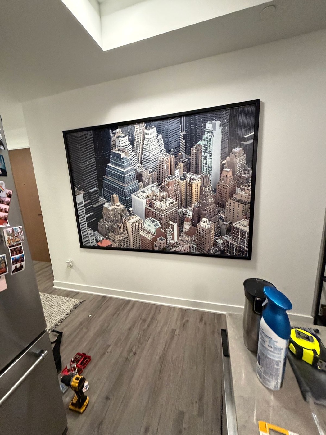 Large cityscape artwork mounted above a sofa in a Toronto condo